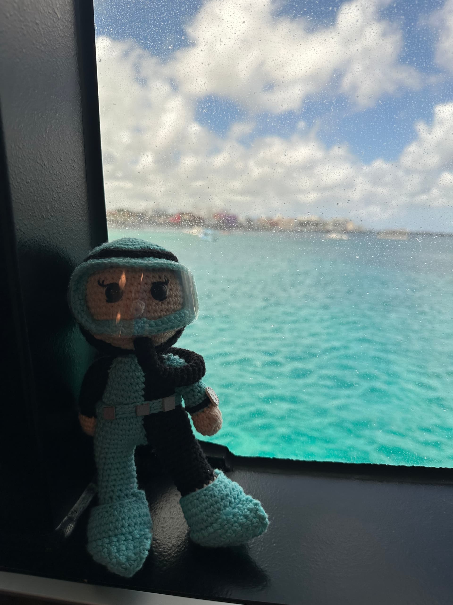 doll sitting by window on a boat