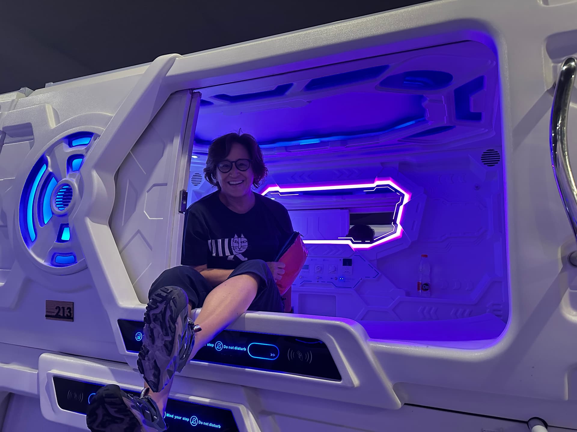 Sitting in front of capsule hotel bed
